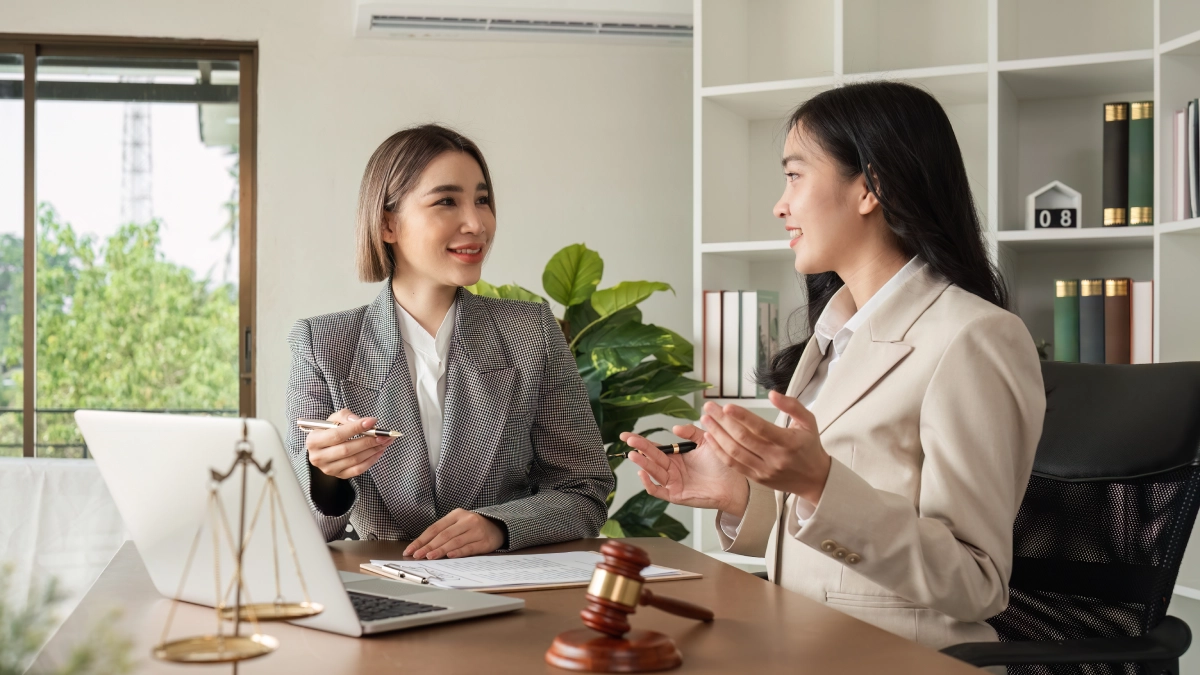 Two women discussing in an office setting.
