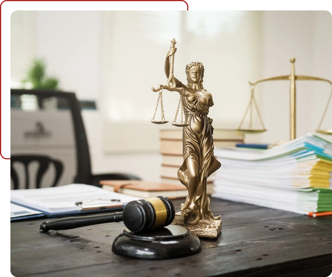 Lady Justice statue and gavel on desk.