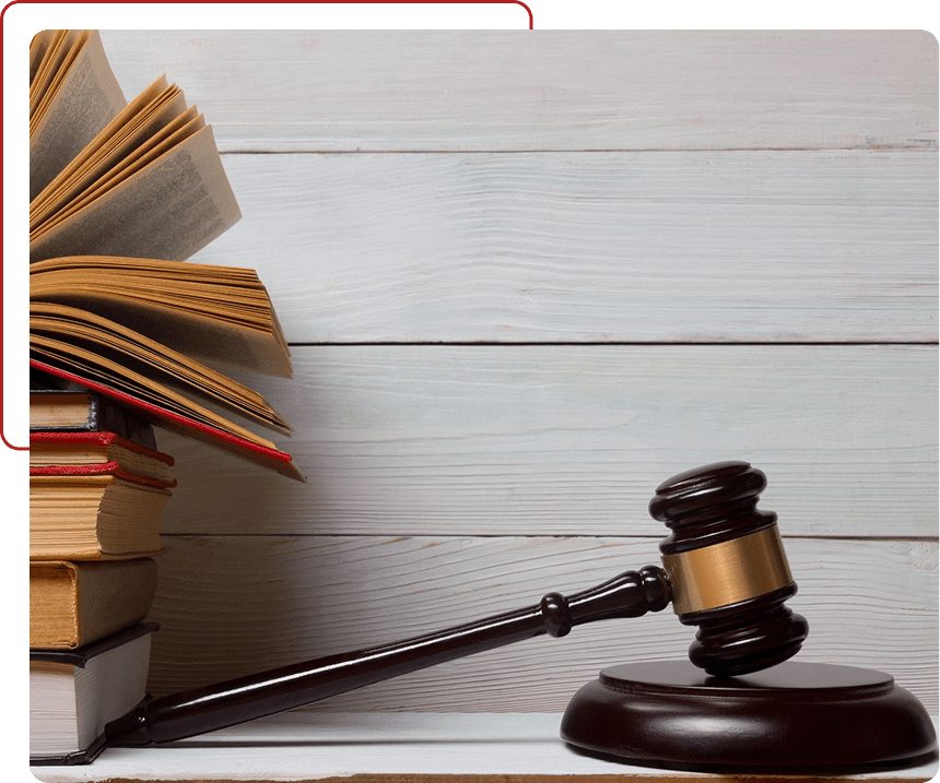 Judge's gavel resting beside an open law book on a wooden table.